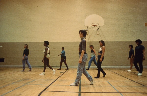 A group of women inmates rehearsing dance in a gym at CIW