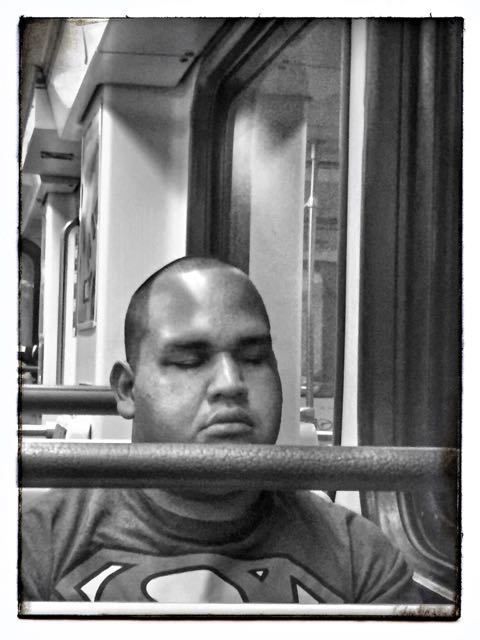 Superman asleep on the LA Metro