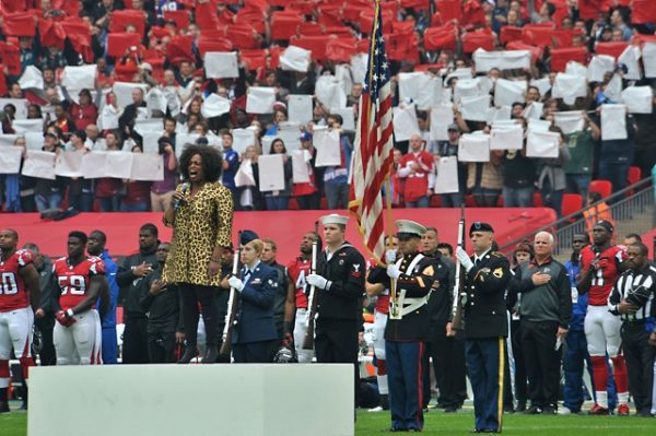 Jazz singer Dianna Reeves sings the U.S. National Anthem as the RAF Molesworth, United Kingdom color guard presents the U.S. flag during the NFL game at Wembly Stadium in London, England Oct. 26, 2014. Every year, London hosts three games as part of the NFL International Series. (U.S. Air Force photo by Staff Sgt. Ashley Hawkins/Released)
