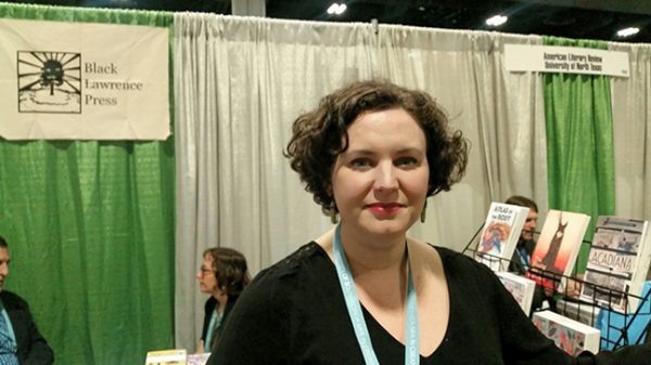 Editor Diane Goettel of Black Lawrence Press stands in front of the press's booth at the AWP book fair