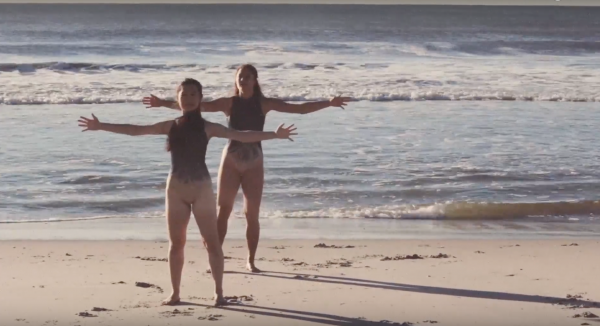 Dancers with arms open wide in "Love"