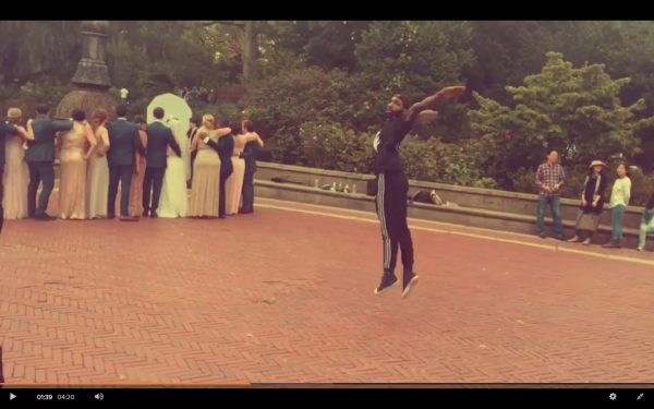 A dancer mid-air during a wedding party photo at Bethesda Fountain 