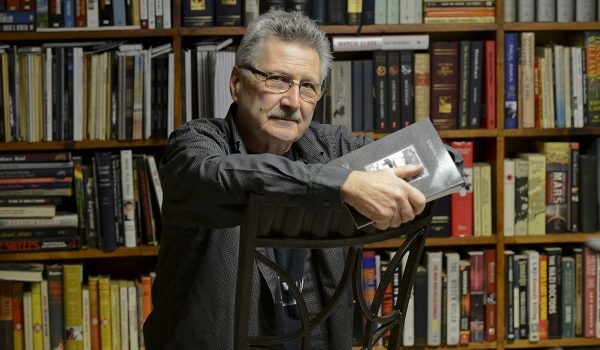 John Yamrus-landscape-books in background-for Interview