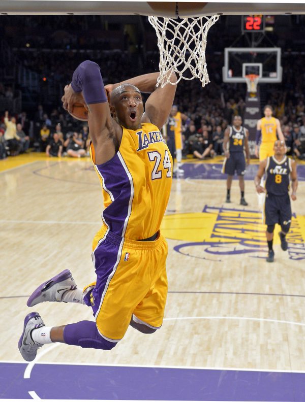 FILE - In this Jan. 25, 2013 file photo, Los Angeles Lakers guard Kobe Bryant goes up for a dunk during the first half of an NBA basketball game against the Utah Jazz, in Los Angeles. The Lakers have signed Bryant to a 2-year contract extension. General manager Mitch Kupchak made the announcement Monday, Nov. 25, 2013, ending speculation that Bryant could end up with another team after this season. (AP Photo/Mark J. Terrill, File)