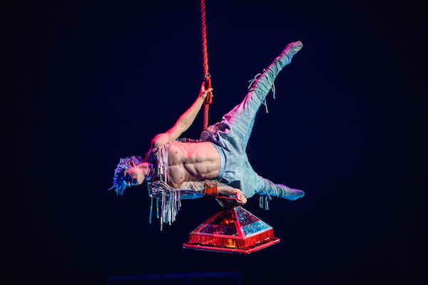 Waz performs aerial feats with the red Acro Lamp.